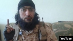 A screen capture from a video of purported Tajik Islamic State militant Abu Kholidi Kulobi. The video appeared online in August 2014.