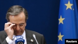 Greek Prime Minister Antonis Samaras adjusts his glasses at a two-day EU leaders summit in Brussels in October, 2012.