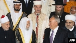 Kazakh President Nursultan Nazarbaev poses for a group picture with participants in the Congress of Leaders of World and Traditional Religions.