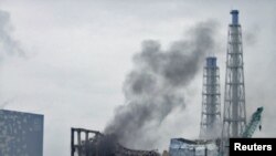 Gray smoke rises from the area of the No. 3 reactor of the Fukushima nuclear power plant today.