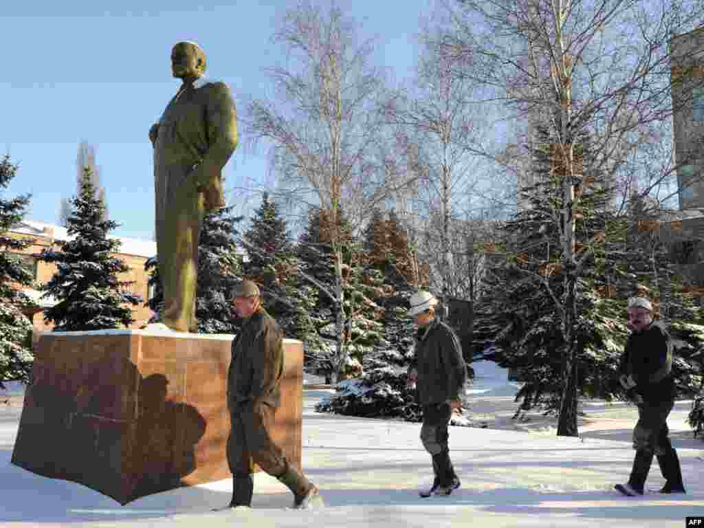 Ukrainian coal miners walk past a statue of Lenin on their way to a polling station in the eastern town of Gorlovka.