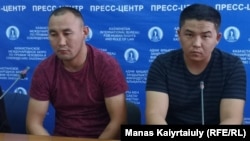 Qaster Musakhanuly (left) and Murager Alimuly speak to the press in Almaty on October 14.