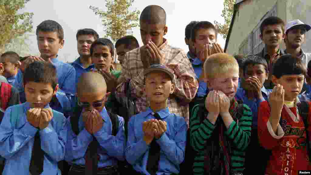 Visually impaired students pray before attending a lesson at the school in Kabul.