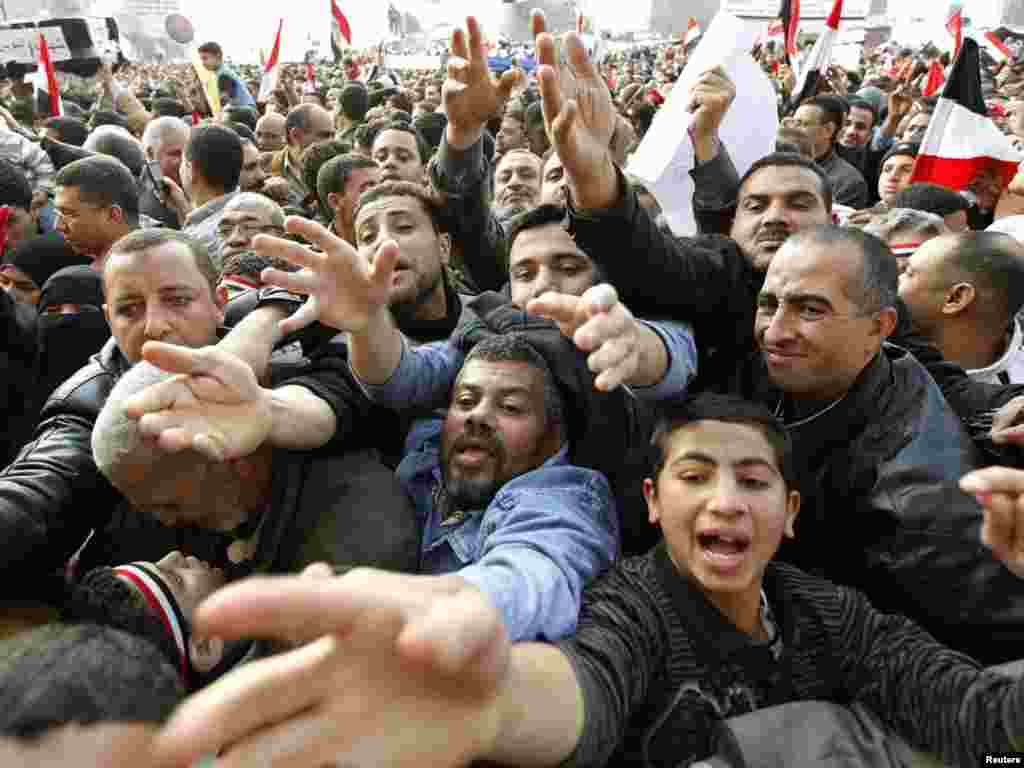 Hungry and thirsty protesters reach out for food and drink during mass demonstrations in Tahrir Square on February 8.