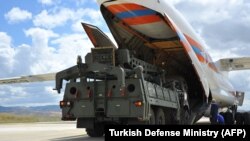 A Russian military cargo plane unloads an S-400 missile-defense system at a military airbase in Turkey in July 2019.