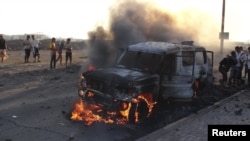 A truck that belonged to Shi'ite Muslim rebels burns during clashes in Aden on March 26.