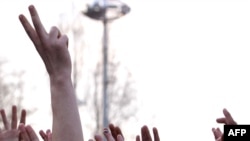 Protesters gesture during a rally near the government building in Chisinau on April 8.