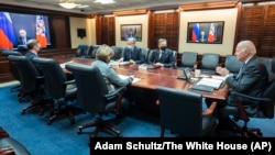 U.S. President Joe Biden (right) speaks to Russian President Vladimir Putin (on-screen) in the Situation Room at the White House on December 7.