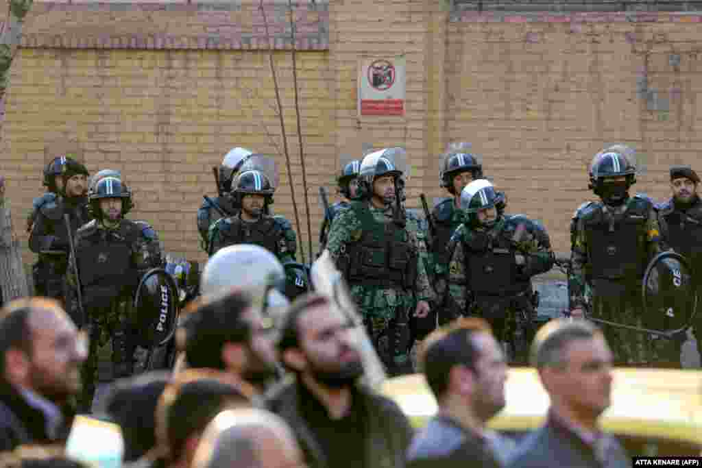 Security forces stand guard in front of the British Embassy in the Iranian capital, Tehran, on January 12. The British ambassador was briefly arrested for allegedly attending an illegal demonstration.