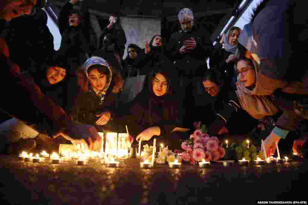 Iranians light candles for all 176 victims of Ukraine International Airlines&nbsp;Flight PS752 during protests in front of Amir Kabir University in Tehran on January 11. The passenger jet was carrying 82 Iranians, 57 Canadians, 11 Ukrainians, 10 Swedes, 10 Afghans, three Germans, and three Britons.