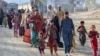 Afghan refugees in Pakistan walk towards the Pakistan-Afghanistan border in Torkham on November 3. 