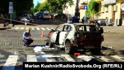 Investigators inspect the site of a car-bomb attack that killed journalist Pavel Sheremet in central Kyiv in July 2016.