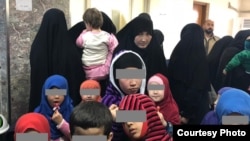 Tajik women and their children await their fate in an Iraqi court in January.