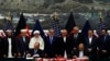 While the chief executive of the Afghan government Abdullah Abdullah (fourth from left) and President Ashraf Ghani (fourth from right) look on, Afghan National security adviser Hanif Atmar (at table,right) and U.S. Ambassador James Cunningham sign a bilateral security agreement in Kabul on September 30.