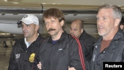 Suspected Russian arms dealer Viktor Bout (center) is escorted by U.S. Drug Enforcement Administration officers after arriving in the United States on November 16.