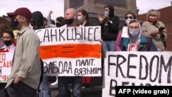 Hundreds of people demonstrate in Warsaw on May 29 in support of the Belarusian opposition.