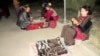 Women sell jewelry at a night market in Mary Province's Bayramaly district.