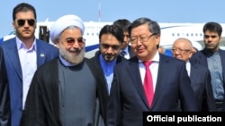 Iranian President Hassan Rohani (front left) and Kyrgyz Prime Minister Jantoro Satybaldiev (front right) ahead of a Bishkek summit 