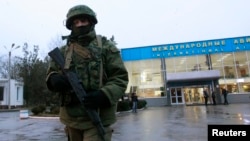 An armed man patrols outside the airport in Simferopol, Crimea's capital, on February 28.