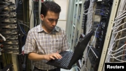 A computer engineer checks equipment at an Internet service provider in Tehran. (file photo)