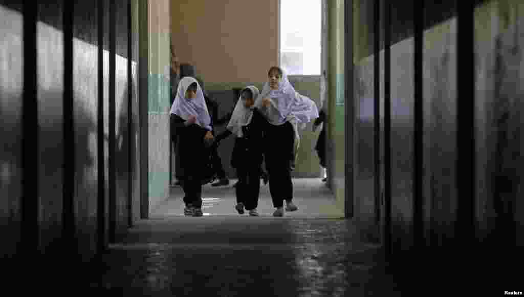 Blind students walk along a corridor at the school.