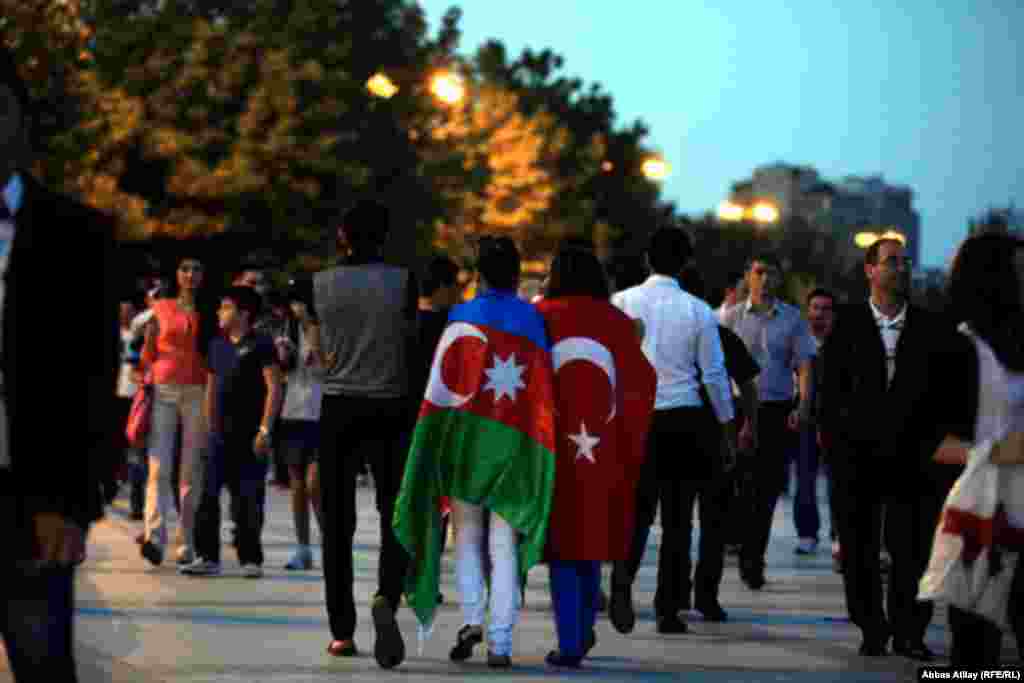 Fans carry the flags of Azerbaijan, Turkey...