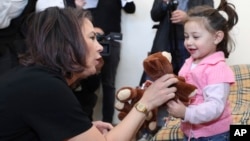 German Foreign Minister Annalena Baerbock gives a teddy bear to a girl as she visits ethnic Armenians who left Nagorno-Karabakh, outside Yerevan on November 4.