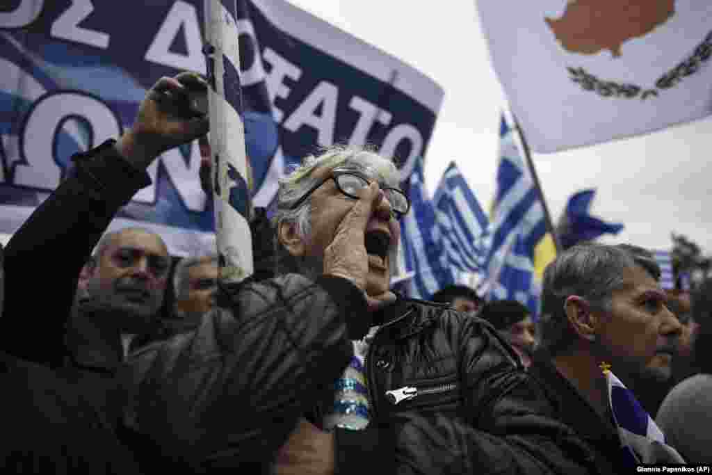 Greeks chant slogans during the protest that police say attracted 90,000 people. Reuters estimated the crowd at &quot;hundreds of thousands.&quot;