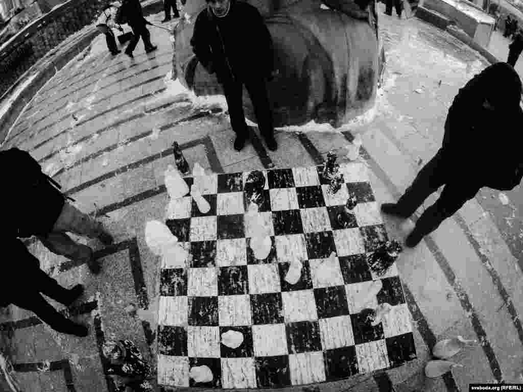 An outdoor chess game in the cold