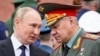 Russian President Vladimir Putin (left) said his decision for a partial military mobilization was made on the recommendation of Defense Minister Sergei Shoigu (right) and the General Staff. (file photo)