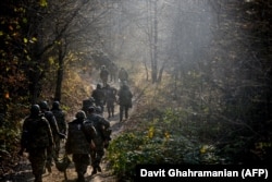 Ethnic Armenian fighters march to their defense positions around the city of Shushi/Susa in Nagorno-Karabakh.