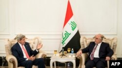 U.S. Secretary of State John Kerry (left) speaks with new Iraqi Prime Minister Haidar al-Abadi in Baghdad on September 10.