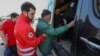 Refugees from Nagorno-Karabakh accompanied by medical workers board a bus at a temporary accommodation center in the village of Kornidzor on September 24. 