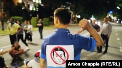 A protester with a sign against former Georgian prime minister Bidzina Ivanishvili.