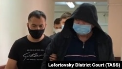 Aleksandr Kuranov is escorted to a hearing at Moscow's Lefortovo district court in August 2021.