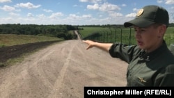 Ukrainian border guard Oksana Ivanets near the frontier fence with Russia in eastern Ukraine