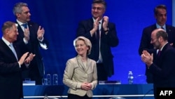 European Commission President Ursula von der Leyen (center) is applauded by (left to right) Romanian President Klaus Iohannis, Austrian Chancellor Karl Nehammer, Croatian Prime Minister Andrej Plenkovic, Greek Prime Minister Kyriakos Mitsotakis, and EPP head Manfred Weber at the EPP congress in Bucharest on March 7.