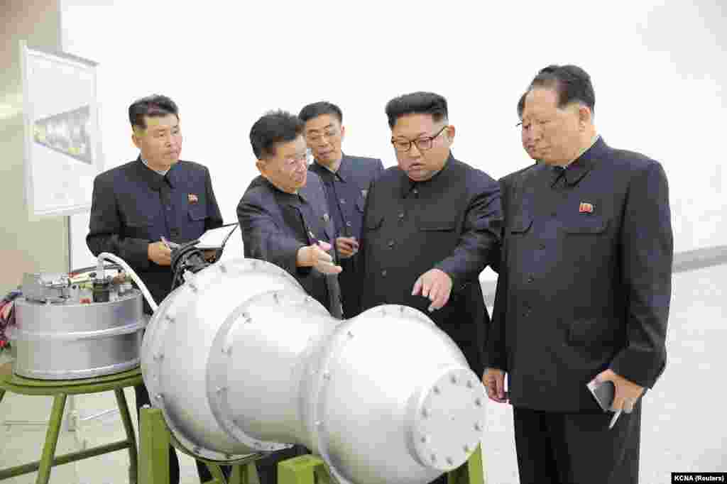 Kim inspecting what North Korean media claimed was a hydrogen bomb small enough to be slotted into an intercontinental ballistic missile (ICBM). The North Korean leader doubled down, responding to Trump&#39;s challenge by threatening U.S. territory (Guam) with &ldquo;an enveloping fire.&rdquo; 