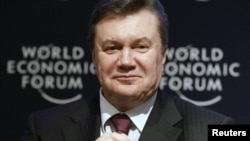 Ukrainian President Viktor Yanukovych attends a session at the World Economic Forum in Davos last year. A new report highlights his administration's lack of progress in implementing economic reform. 