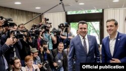 Macedonian Prime Minister Zoran Zaev (left) and his Greek counterpart Alexis Tsipras smile for reporters at a meeting in Sofia on May 17. 