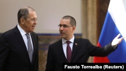 Russian Foreign Minister Sergei Lavrov (left) arrives for a meeting with his Venezuelan counterpart, Jorge Arreaza, in Caracas on February 7.