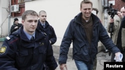 Prominent anticorruption blogger Aleksei Navalny (right) arrives for an appeal hearing at a court in Moscow on December 7. Has the Kremlin made him into an opposition icon by arresting him?