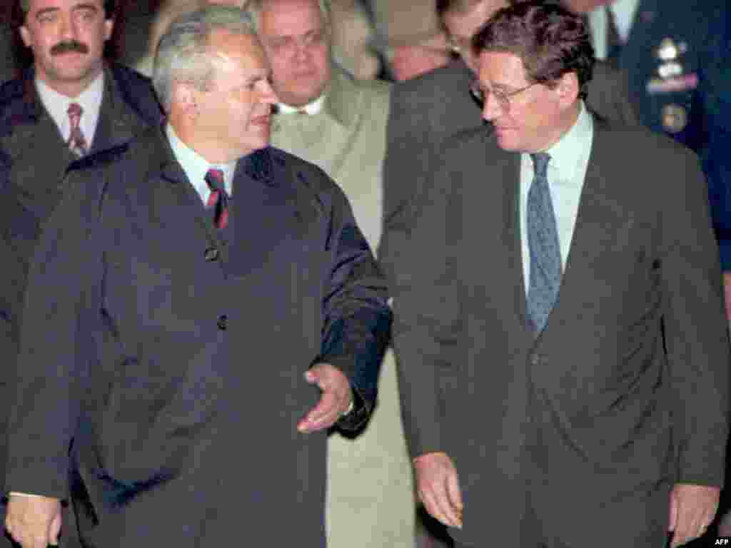 Serbian President Slobodan Milosevic is greeted by U.S. Assistant Secretary of State Richard Holbrooke after arriving at Wright-Patterson Air Force Base near Dayton on October 31, 1995, to attend the Balkan peace talks.