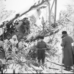 A downed Soviet plane being picked apart by a Finnish patrol.