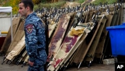 A policeman walks past blood-stained stretchers at a morgue in Stepanakert, the main city in Nagorno-Karabakh, on November 6.