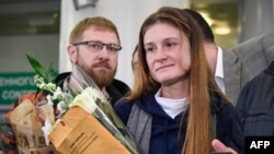 Maria Butina, who served nine months in a U.S. prison for acting as a Russian government agent, arrives at Moscow's Sheremetyevo airport on October 26, a day after her release. 