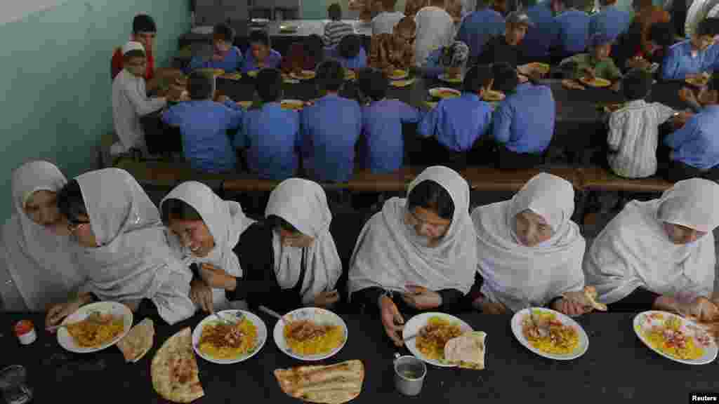 Visually impaired and blind students eat their meals at the school.