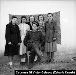 Tokarchuk in his military uniform posing with local girls. Tamara is standing second from right.