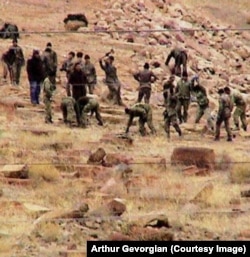 Men working with sledgehammers at the Julfa cemetery in December 2005.