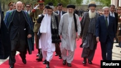 Former Afghan President Hamid Karzai, Afghan President Ashraf Ghani, Afghan warlord Gulbuddin Hekmatyar, Afghan former jihadi leader Abdul Rabb Rasool Sayyaf, and Afghanistan Chief Executive Abdullah Abdullah attend a ceremony together in 2017.